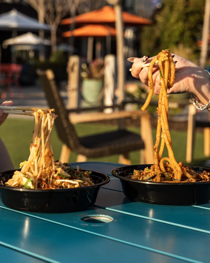 Noodles being lifted with chopsticks at Dang Dude
